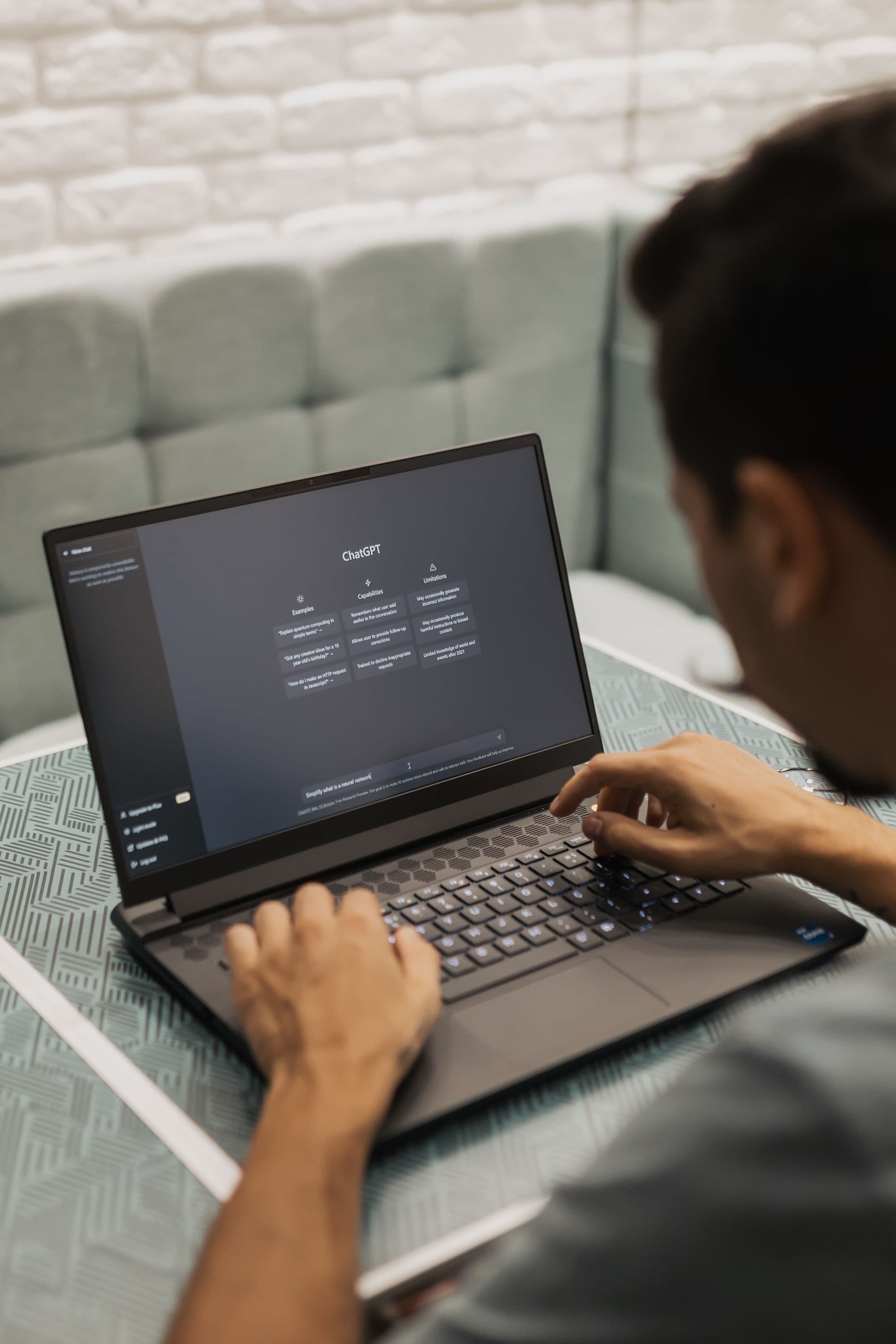 Professionals using AI on a laptop in a workshop