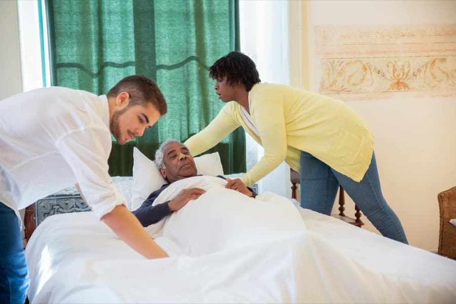 Care staff practising safe people-handling techniques during a practical training session
